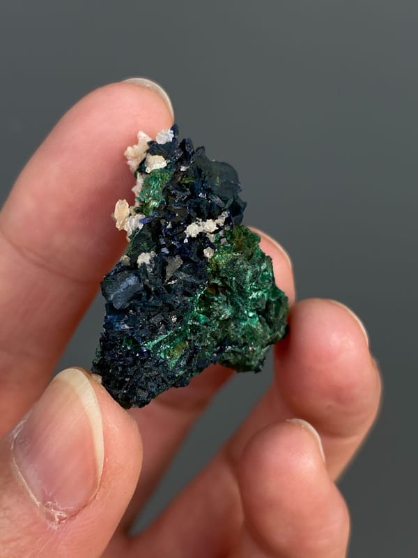 Deep green malachite with white crystals on top from Anhui, China, detail of the matrix contact
