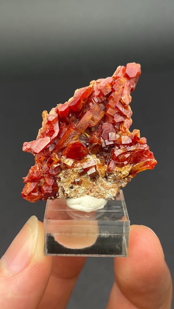 Thin plate stacked with red vanadinite crystals from Morocco, second angle