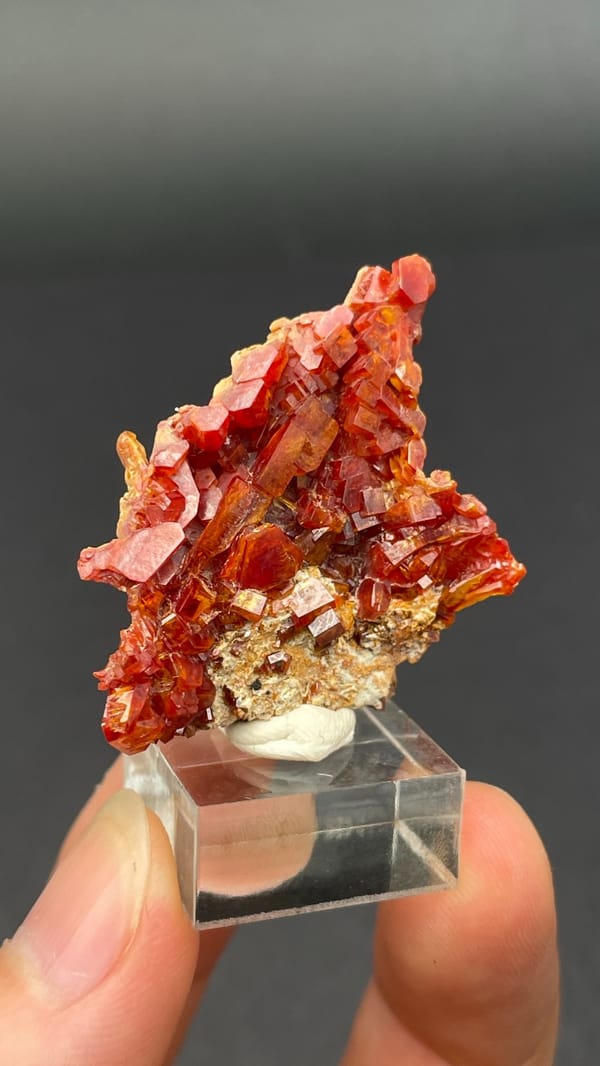Thin plate stacked with red vanadinite crystals from Morocco, top view