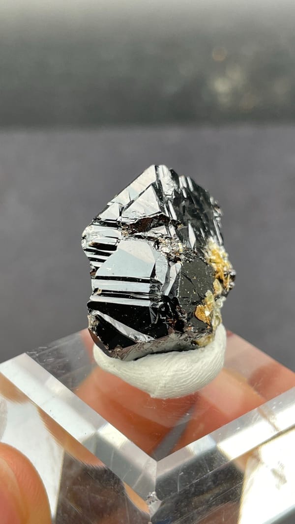 Black lustrous cassiterite crystal group from Xuebaoding, Sichuan, China, close-up of the crystal faces