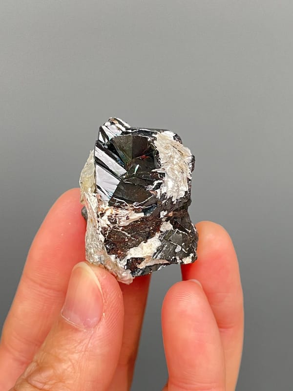 Black cassiterite crystal with silvery mica from Xuebaoding, Sichuan, China, second angle