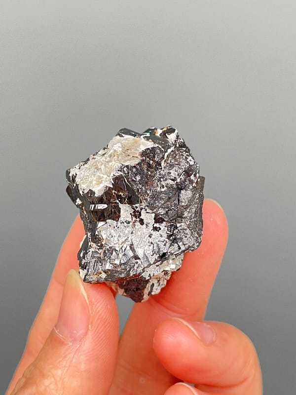Black cassiterite crystal with silvery mica from Xuebaoding, Sichuan, China, reverse side