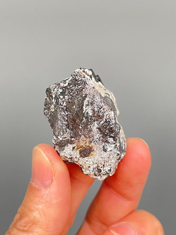 Black cassiterite crystal with silvery mica from Xuebaoding, Sichuan, China, top view