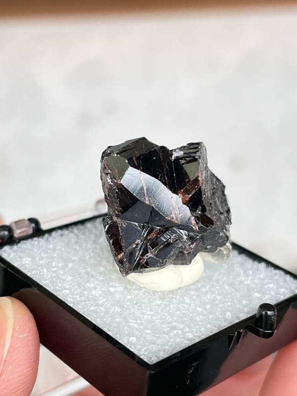 Black cassiterite crystal group from Xuebaoding, Sichuan, China, in a box, second angle