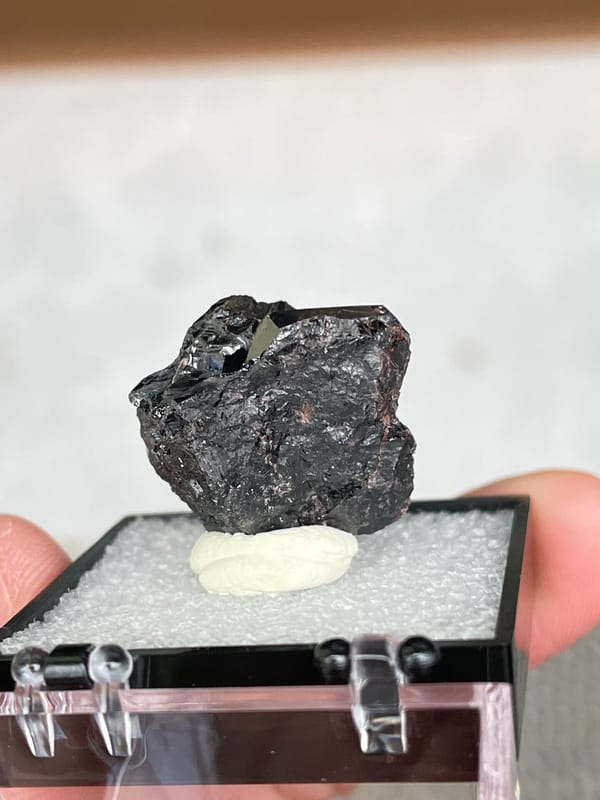 Black cassiterite crystal group from Xuebaoding, Sichuan, China, in a box, top view