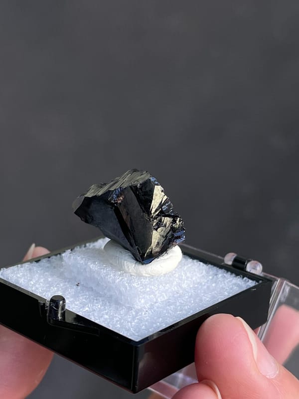 Wedge-shaped black cassiterite crystal from Xuebaoding, Sichuan, China, close-up of the crystal faces