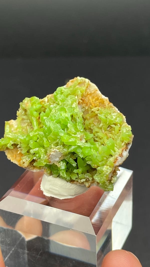 Apple-green pyromorphite crust on tan matrix from Guangxi, China, close-up of the crystal faces