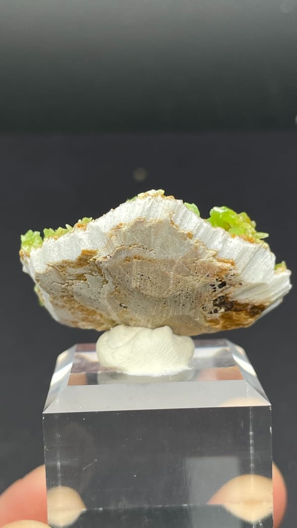 Apple-green pyromorphite crust on tan matrix from Guangxi, China, detail of the matrix contact