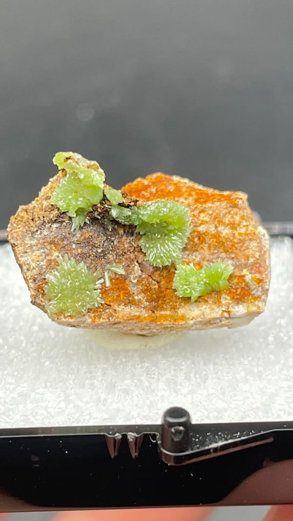 Apple-green pyromorphite tufts on an orange matrix slab from Guangxi, China, second angle