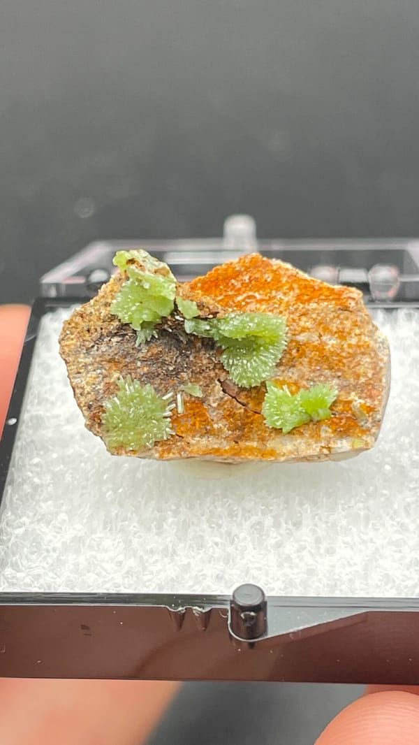 Apple-green pyromorphite tufts on an orange matrix slab from Guangxi, China, top view