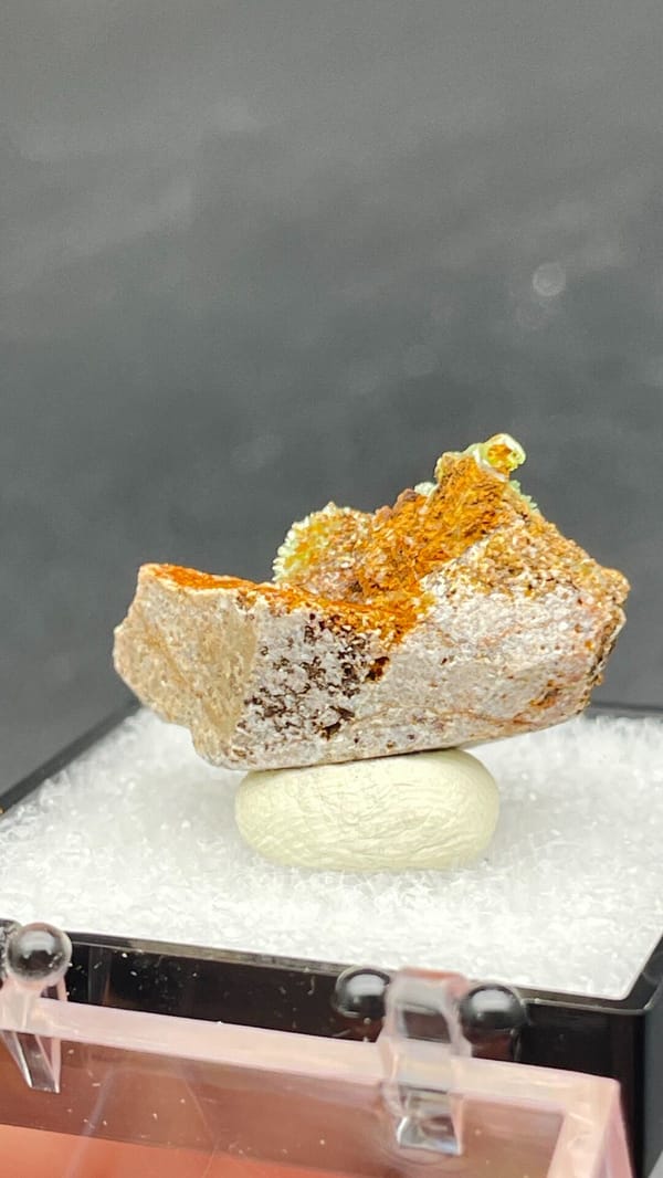 Apple-green pyromorphite tufts on an orange matrix slab from Guangxi, China, detail of the matrix contact