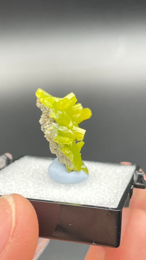 Vivid lemon-yellow pyromorphite cluster on dark base from Guangdong, China, close-up of the crystal faces