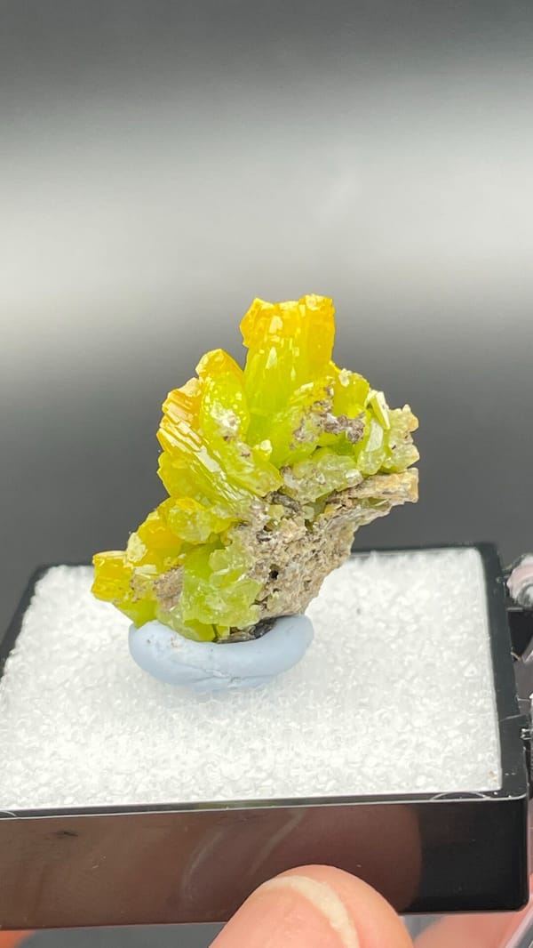 Canary-yellow stacked pyromorphite crystals from Guangdong, China, in a box, detail of the matrix contact
