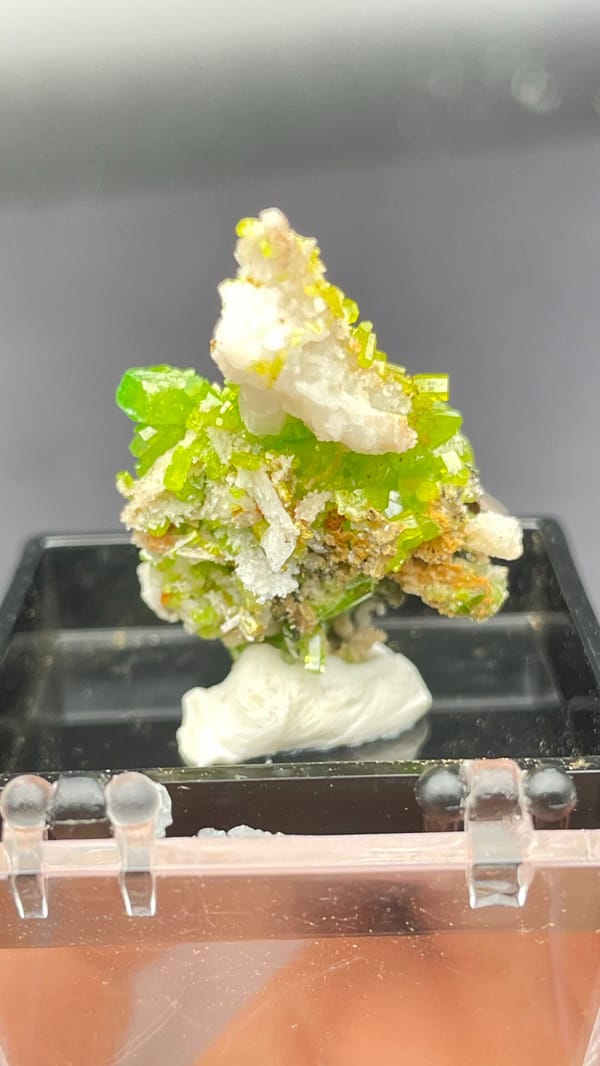 Bright lime-green stacked pyromorphite crystals from Guangdong, China, in a box, close-up of the crystal faces
