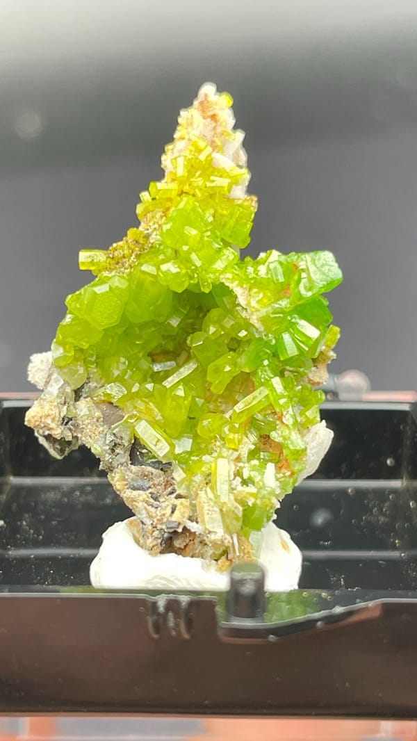 Bright lime-green stacked pyromorphite crystals from Guangdong, China, in a box, side view
