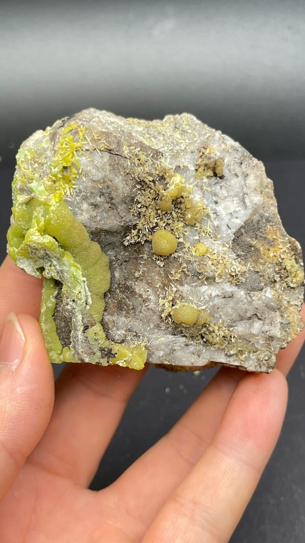 Yellow-green pyromorphite patches on a pale quartz rock from Guangdong, China, side view