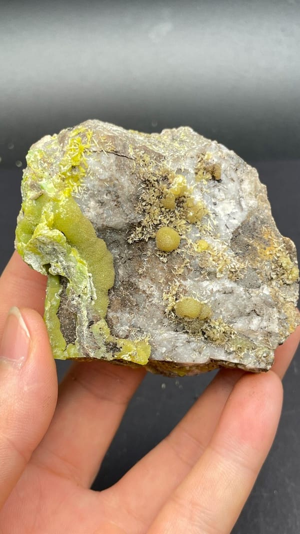 Yellow-green pyromorphite patches on a pale quartz rock from Guangdong, China, close-up of terminations
