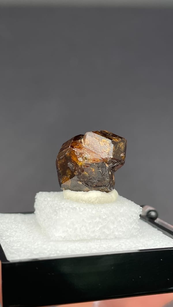 Amber-brown dodecahedral andradite garnet crystal from Handan, Hebei, China, close-up of the crystal faces