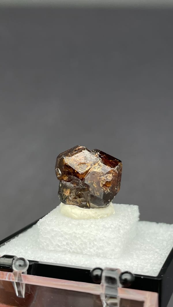 Amber-brown dodecahedral andradite garnet crystal from Handan, Hebei, China, reverse side