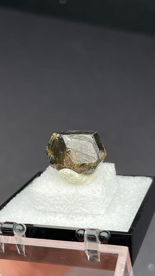 Brown dodecahedral andradite garnet crystal from Handan, Hebei, China, in a box, reverse side
