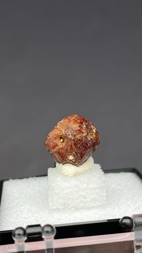 Small reddish-brown dodecahedral andradite garnet from Handan, Hebei, China, close-up of the crystal faces