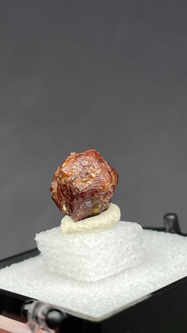 Small reddish-brown dodecahedral andradite garnet from Handan, Hebei, China, reverse side