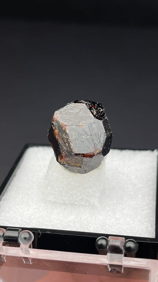 Dark brown dodecahedral andradite garnet single crystal from Handan, Hebei, China, close-up of the crystal faces