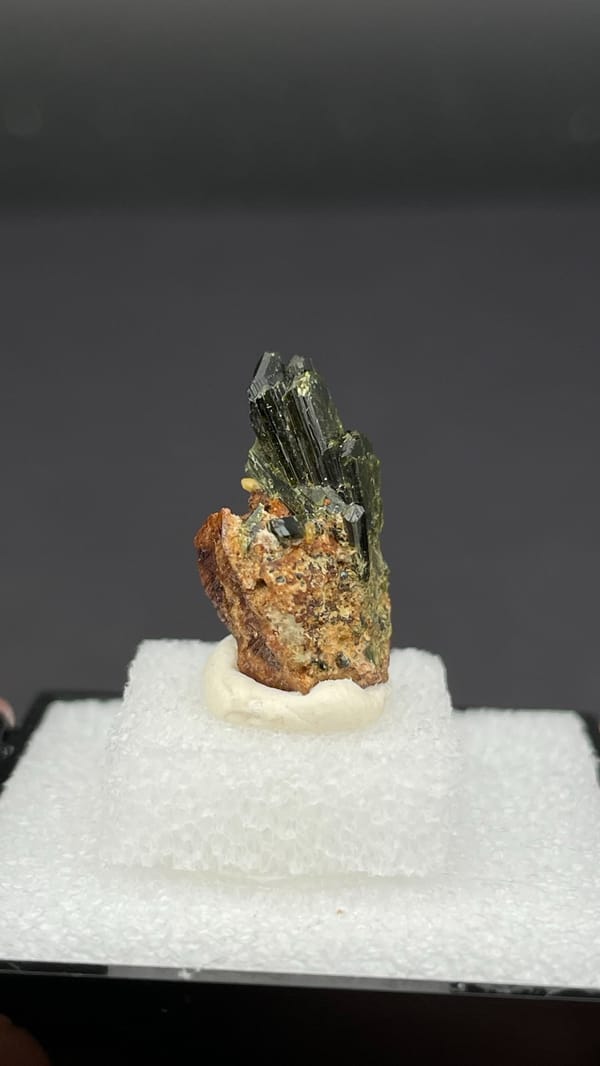 Fan of olive-green epidote blades on brown garnet from Handan, Hebei, China, close-up of the crystal faces