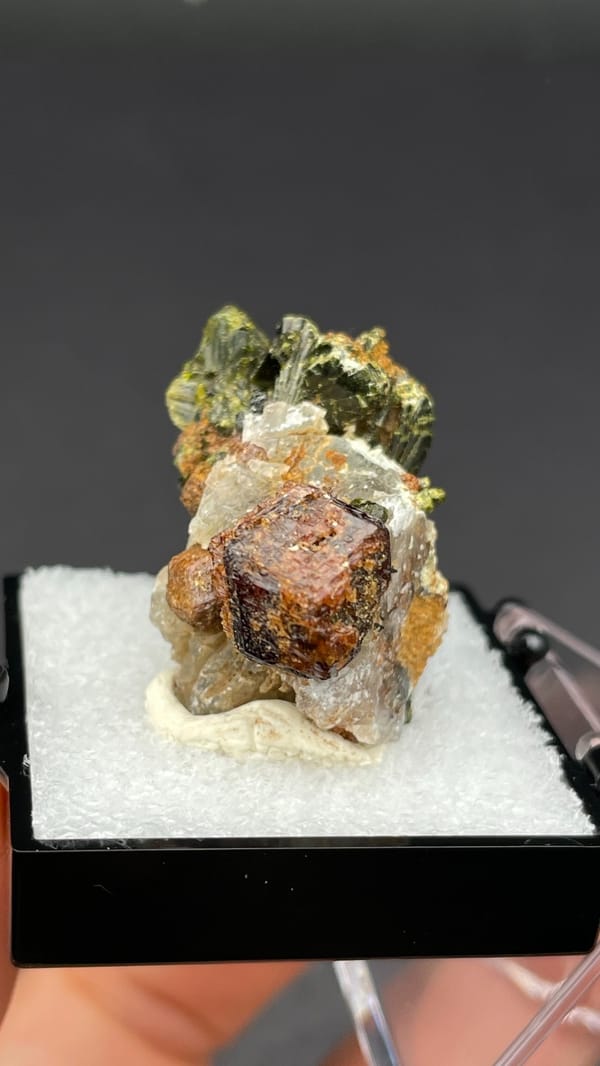 Brown garnet dodecahedra with fanned olive epidote blades, Handan, Hebei, China, close-up of the crystal faces