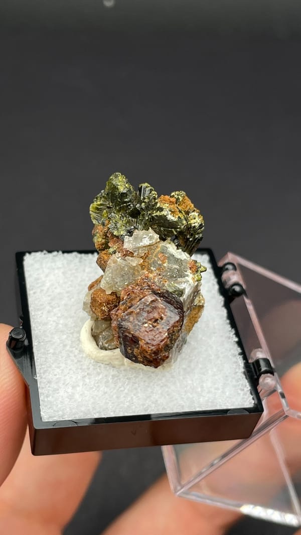 Brown garnet dodecahedra with fanned olive epidote blades, Handan, Hebei, China, detail of the matrix contact