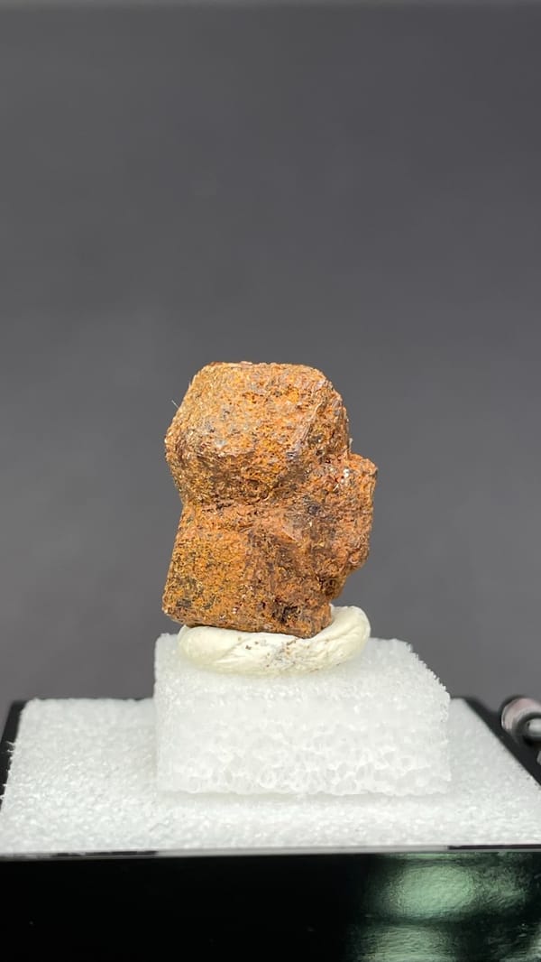 Rough orange-brown dodecahedral andradite garnet from Handan, Hebei, China, close-up of the crystal faces