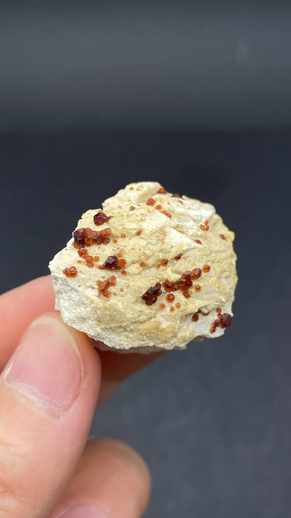 Dark red garnet crystals in cream matrix from Fujian, China, second angle