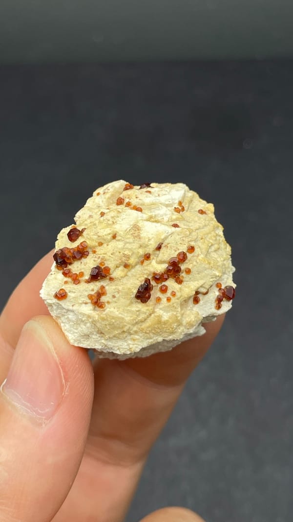 Dark red garnet crystals in cream matrix from Fujian, China, top view