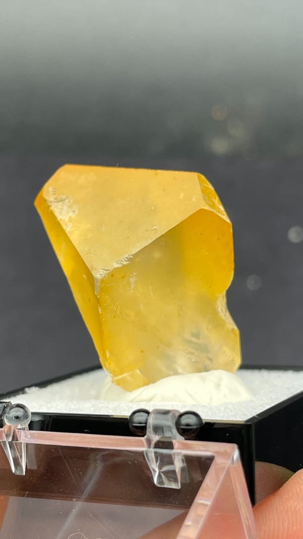 Amber-coloured baryte crystal from Jinkouhe, Sichuan, China, in a display box, top view
