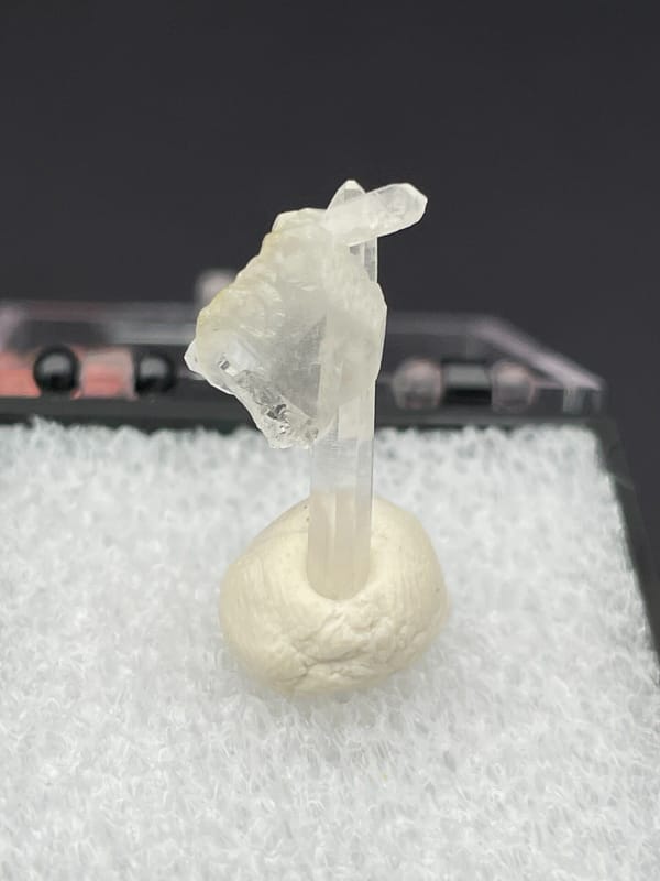 Thin white baryte blade with a quartz needle, Jinkouhe, Sichuan, China, detail of the matrix contact