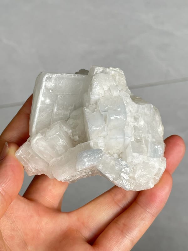 Large white-grey blocky baryte crystal group from Jinkouhe, Sichuan, China, close-up of the crystal faces