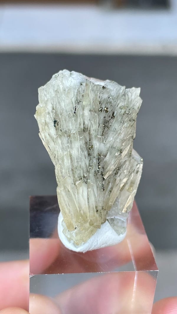Pale grey-green bladed baryte from Morocco, on an acrylic stand, second angle