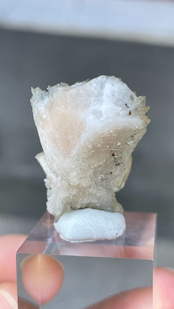 Pale grey-green bladed baryte from Morocco, on an acrylic stand, detail of the matrix contact