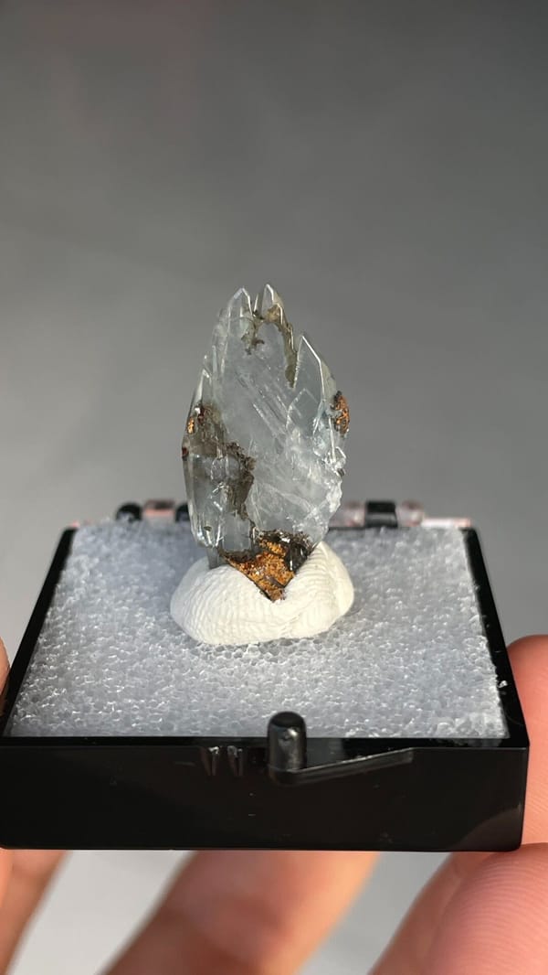 Pale blue transparent baryte crest on orange matrix from Morocco, in a box, second angle