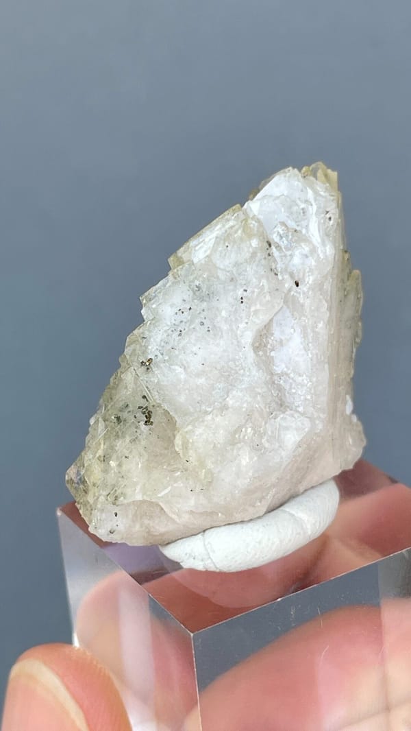 Pale straw-coloured bladed baryte fan from Morocco, on an acrylic stand, top view