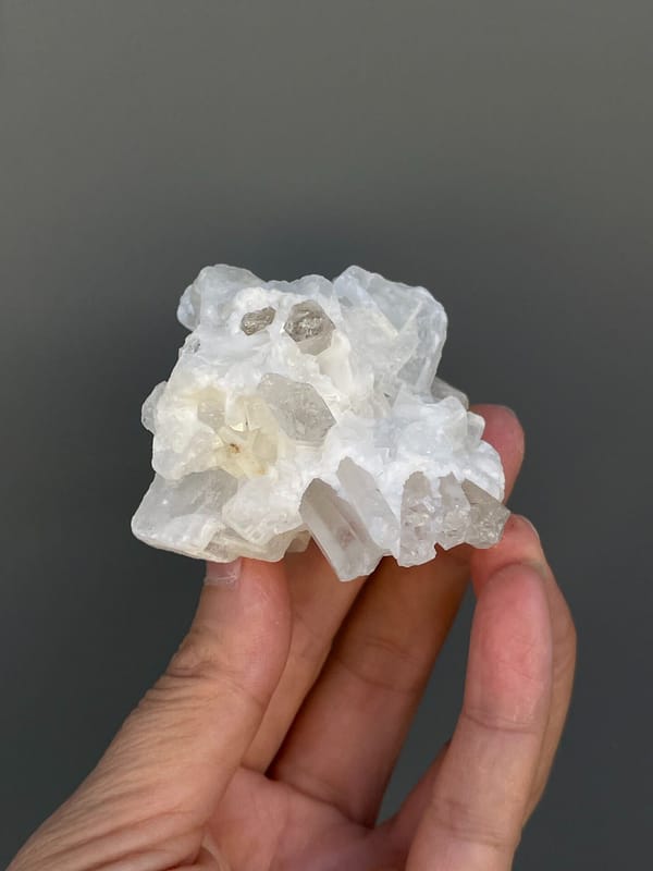 White blocky baryte with clear quartz points from Jinkouhe, Sichuan, China, detail of the matrix contact
