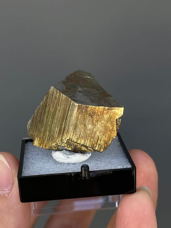 Brassy striated pyrite crystal from Yunnan, China, in a display box, second angle