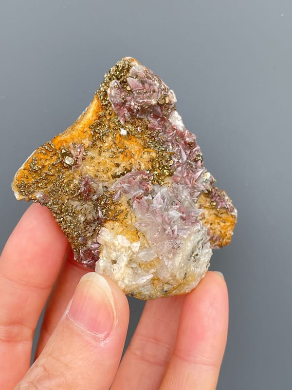 Golden pyrite crust over pale pink calcite from Hubei, China, second angle