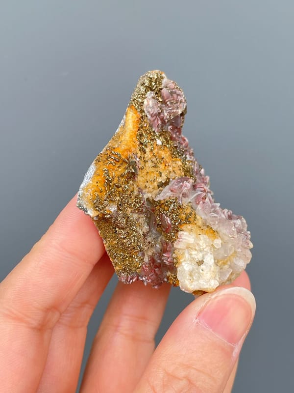 Golden pyrite crust over pale pink calcite from Hubei, China, reverse side