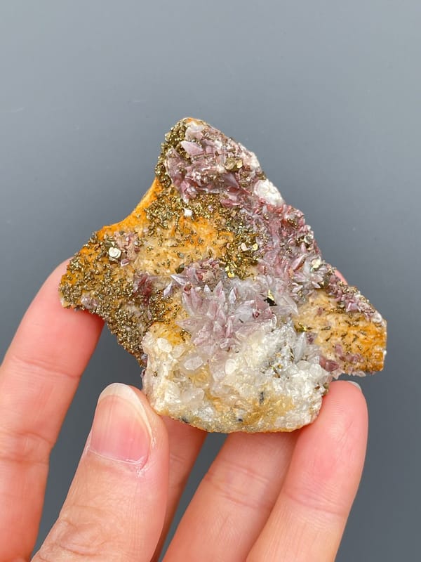 Golden pyrite crust over pale pink calcite from Hubei, China, top view