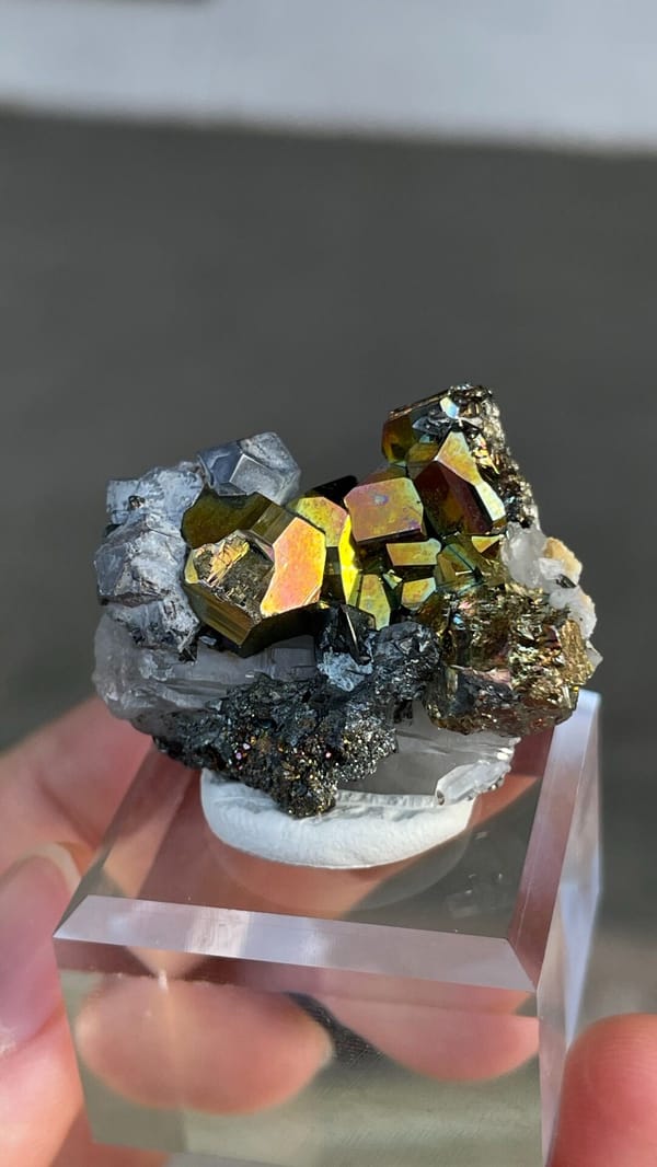 Iridescent pyrite crystals with grey galena from Peru, on an acrylic stand, reverse side