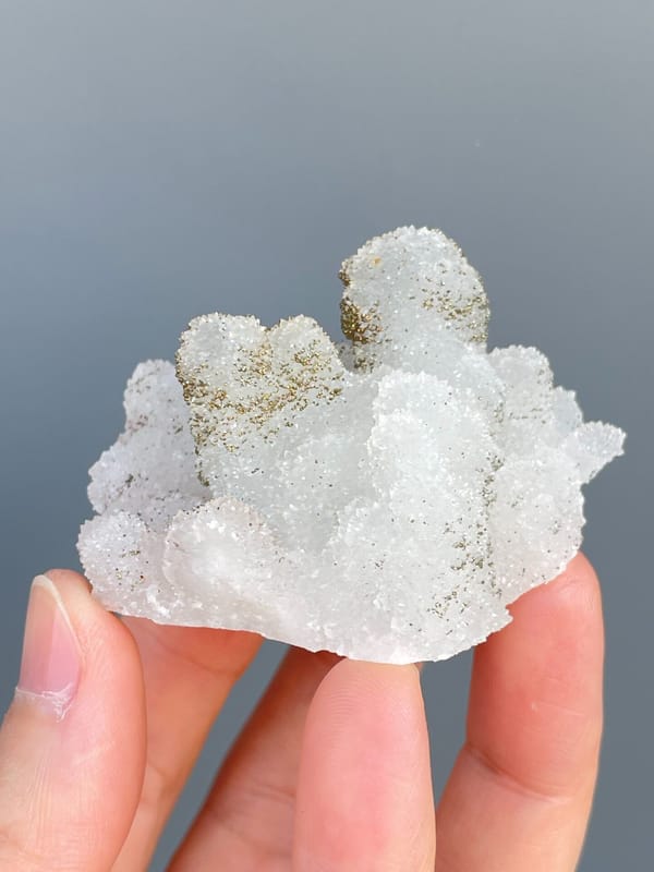 Golden pyrite crusting the tops of white quartz mounds from Fujian, China, top view