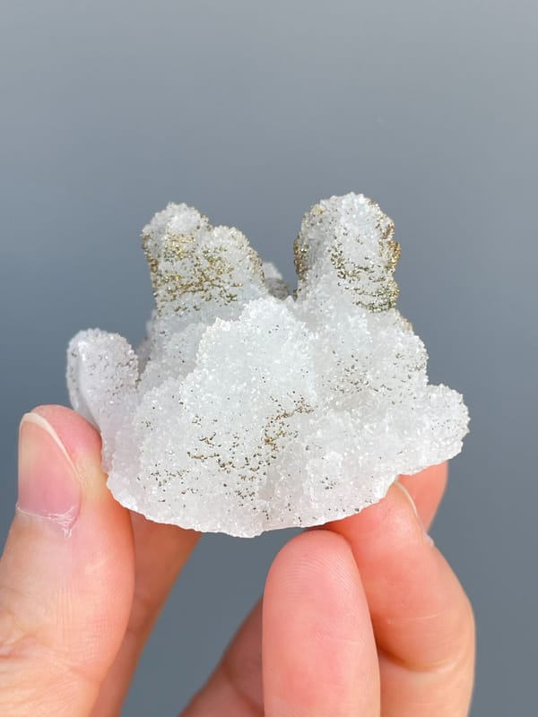 Golden pyrite crusting the tops of white quartz mounds from Fujian, China, detail of the matrix contact