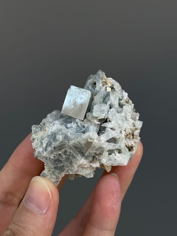 Pale metallic pyrite crystal on grey matrix from Shangbao, Hunan, China