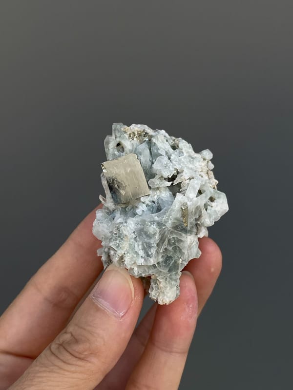 Pale metallic pyrite crystal on grey matrix from Shangbao, Hunan, China, top view